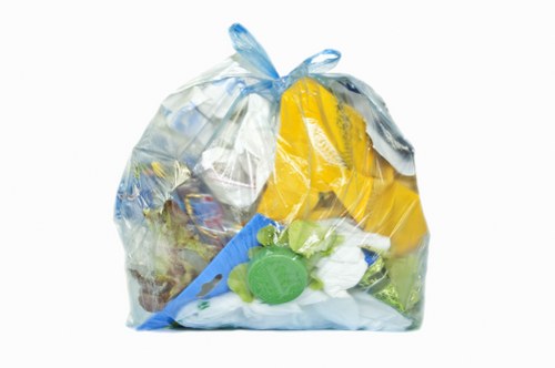 Recycling bins and commercial waste containers on a Notting Hill street